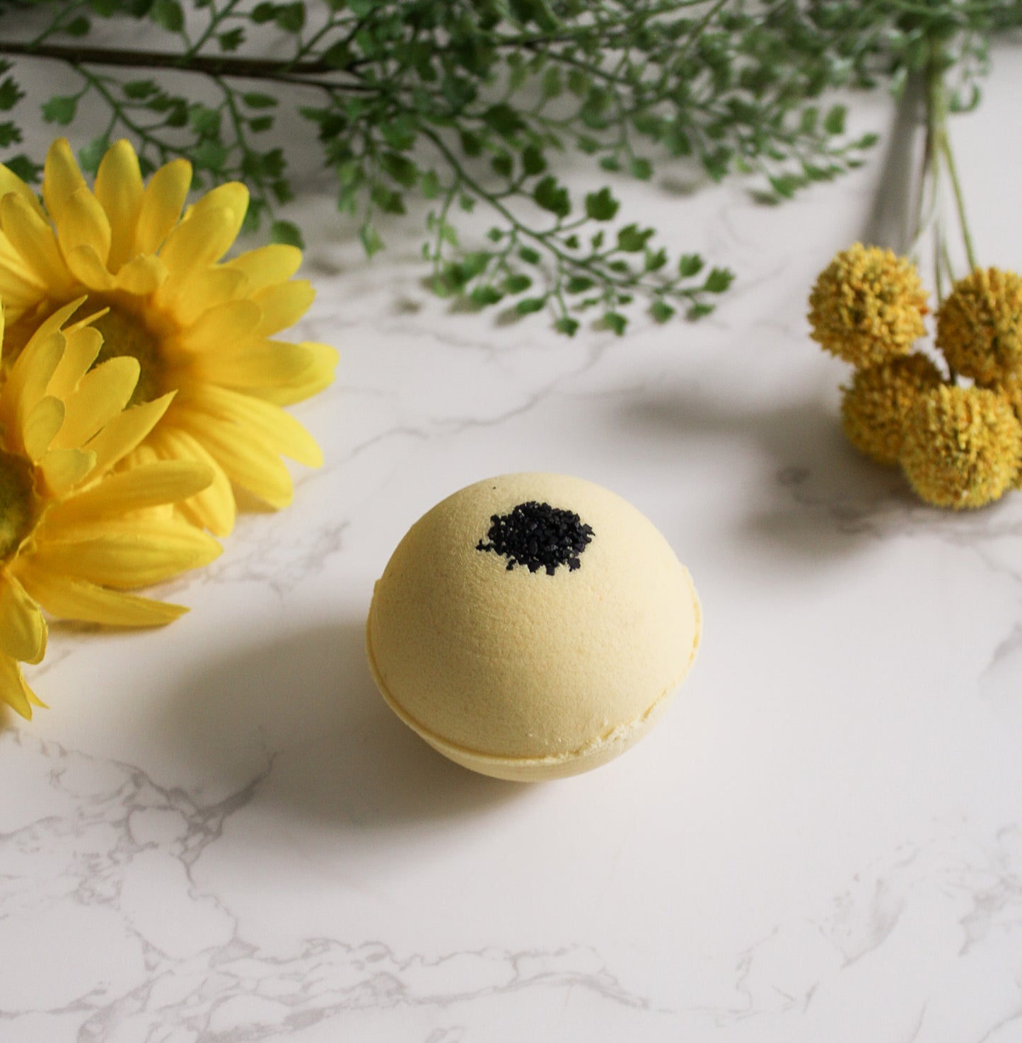 Chamomile Noir Bath Bomb, yellow with Black Sea salt on top