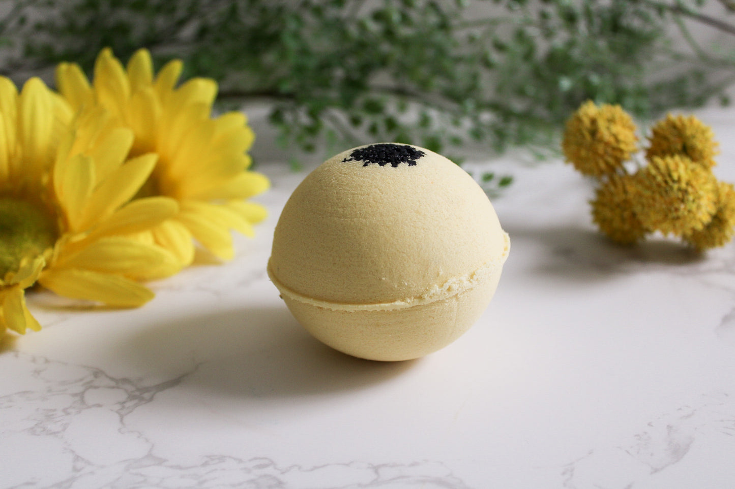 Chamomile Noir Bath Bomb, yellow with Black Sea salt on top